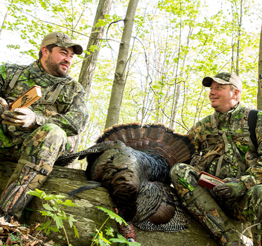 Turkey hunters on log